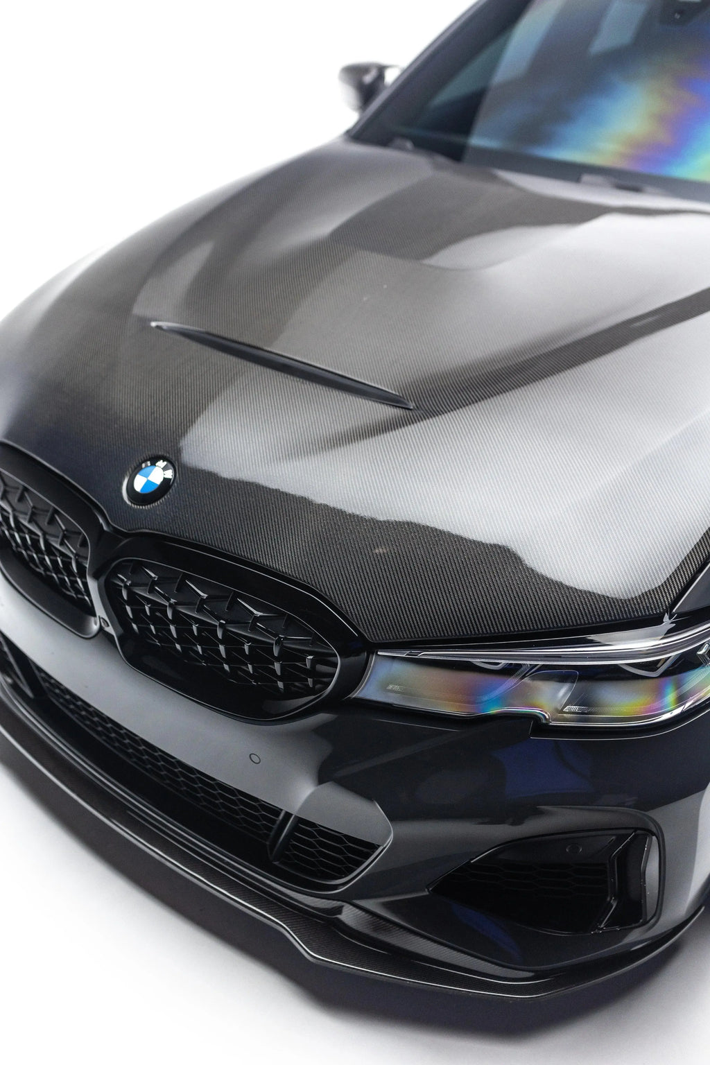 Black BMW G20 front close-up: carbon front lip under the bumper and carbon hood (V Style V2)