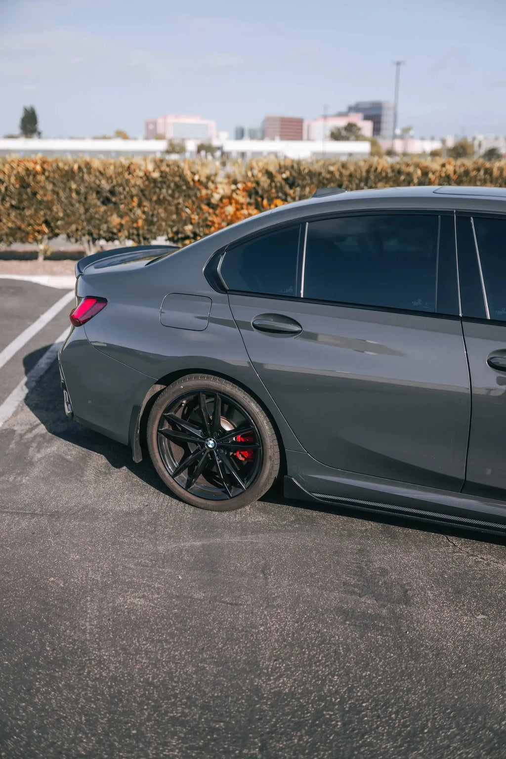 Gray BMW G20, rear side three-quarter view, with fitted carbon side skirt (TK Style)