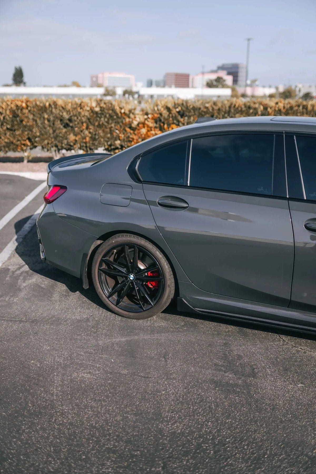 Gray BMW G20, rear side three-quarter view, with fitted carbon side skirt (TK Style)