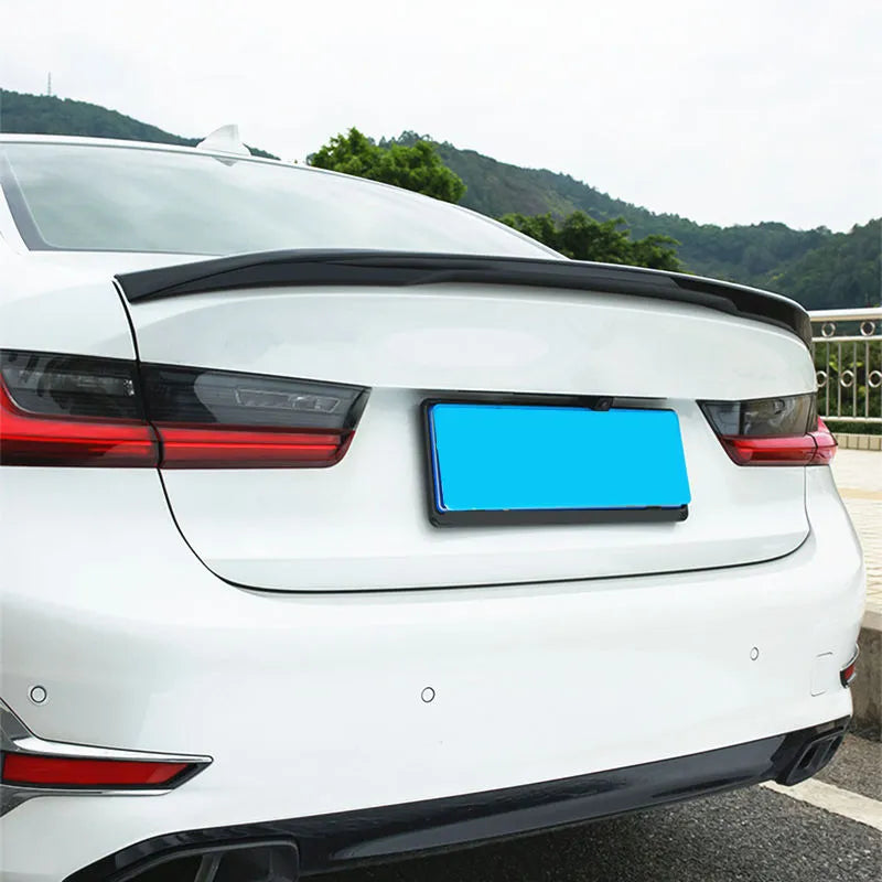 Close-up of a white BMW G20 rear with fitted carbon trunk spoiler (Performance Style)