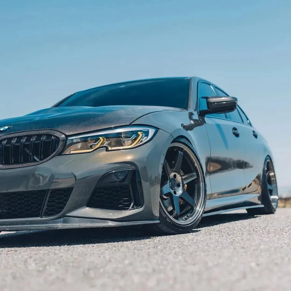 Gray pre-LCI BMW G20 from a low three-quarter angle, LED headlights with yellow DRL (Laser Style)