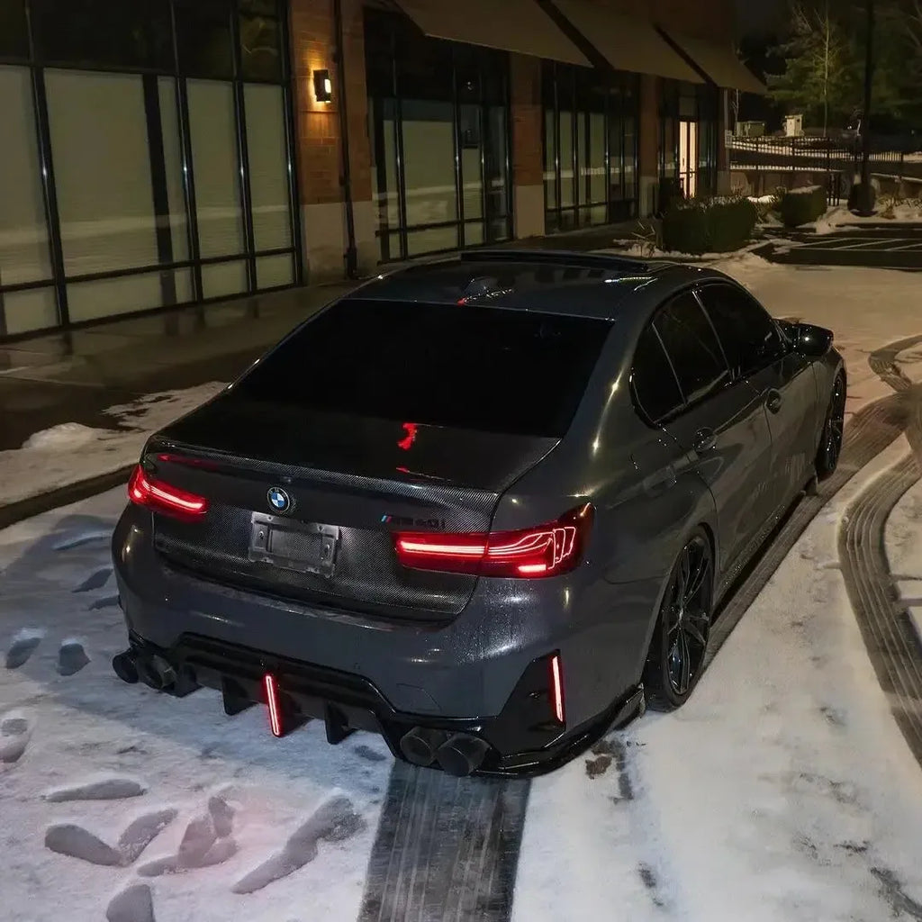 Gray BMW G20 M340i from the rear at night in the snow, illuminated red tail lights (CSL Style V1)