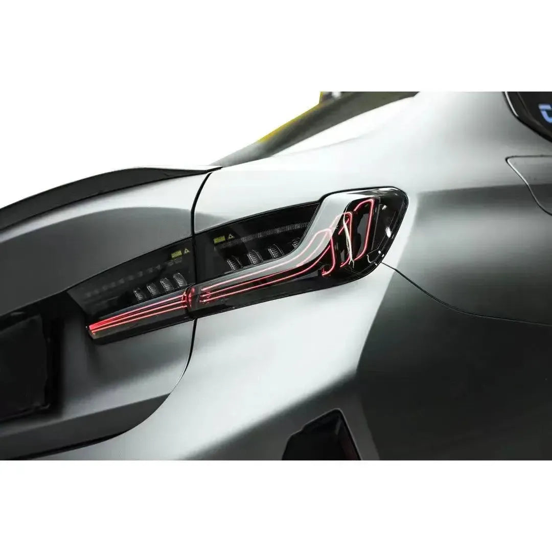 Matte gray BMW G20 from the side-rear, smoked LED tail light glowing red (CSL Style V2)