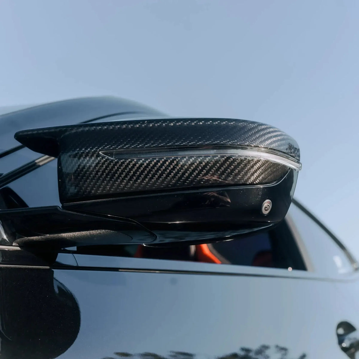 Carbon mirror cap on a black BMW G20, low-angle close-up (M Style)