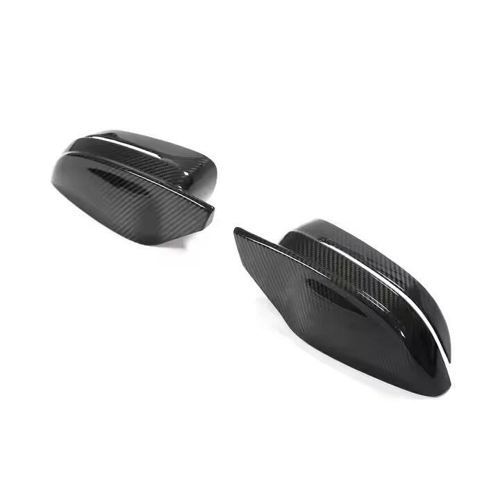 Two carbon mirror caps with pointed upper edge, three-quarter view (M Style) – BMW G20 3 Series