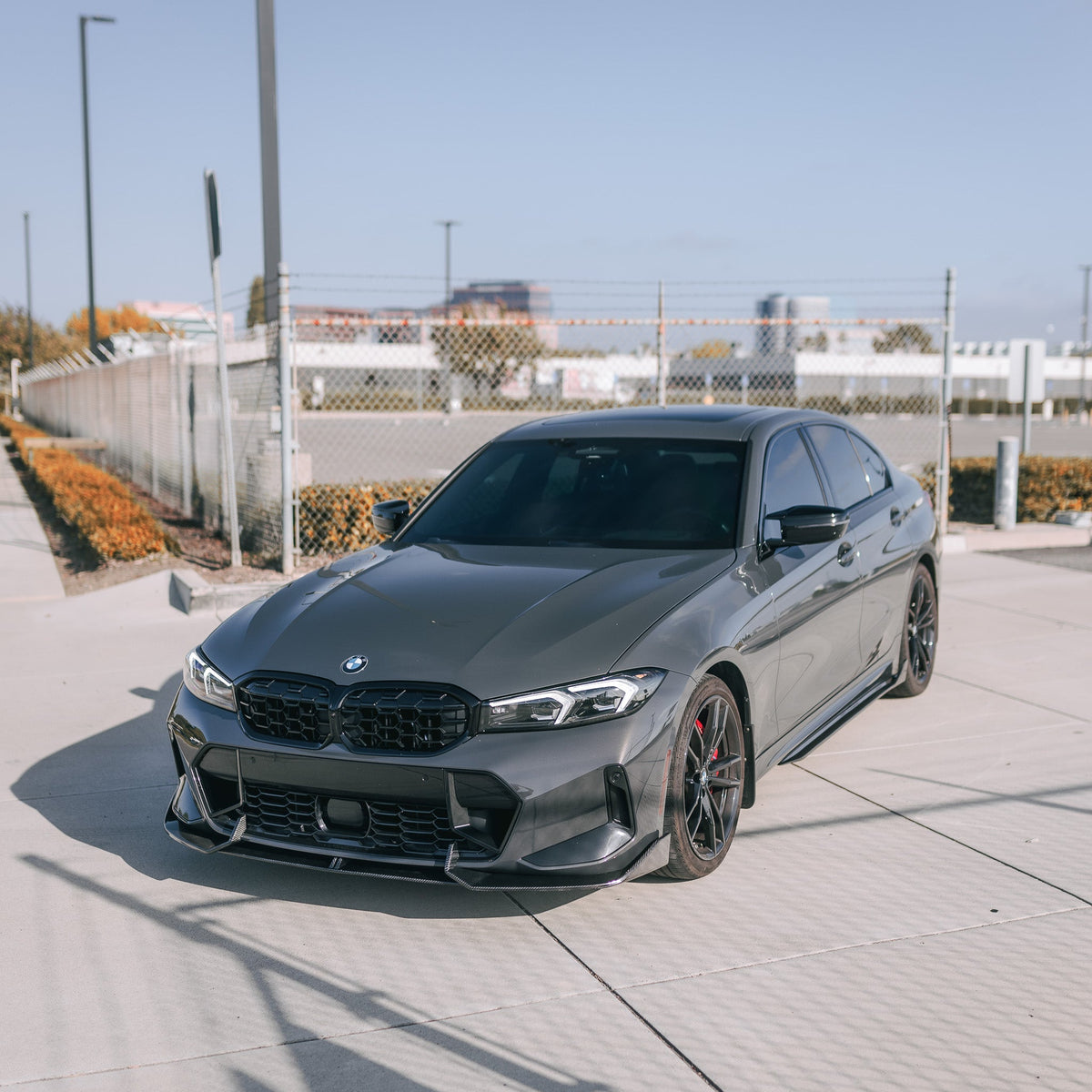 Gray BMW G20 LCI, front three-quarter view, with fitted gloss black diamond-pattern kidney grille (Diamond Style)