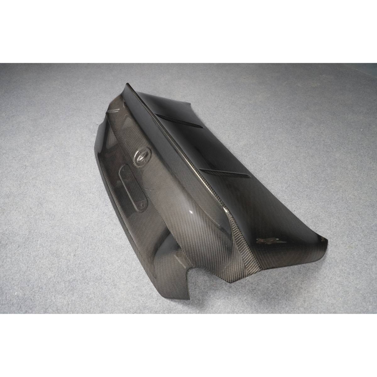 Carbon fiber trunk lid, side three-quarter view, on a gray background (CS Style) – BMW G87 M2