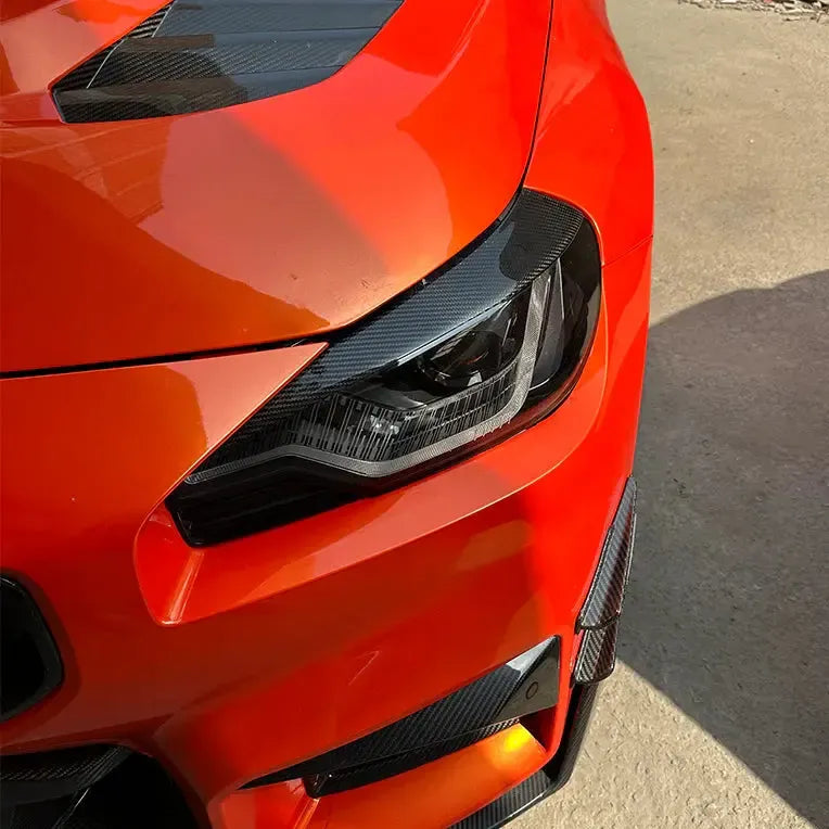 Narancssárga BMW G87 M2 jobb első fényszórója felszerelt carbon fényszóró szemöldökkel
