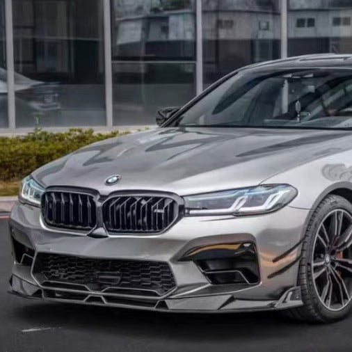 Silver LCI BMW F90 M5 front three-quarter view, with fitted carbon front lip and kidney grille (Track Style)