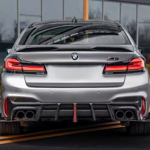 Silver LCI BMW F90 M5 from behind, with carbon trunk spoiler and rear diffuser (Track Style)