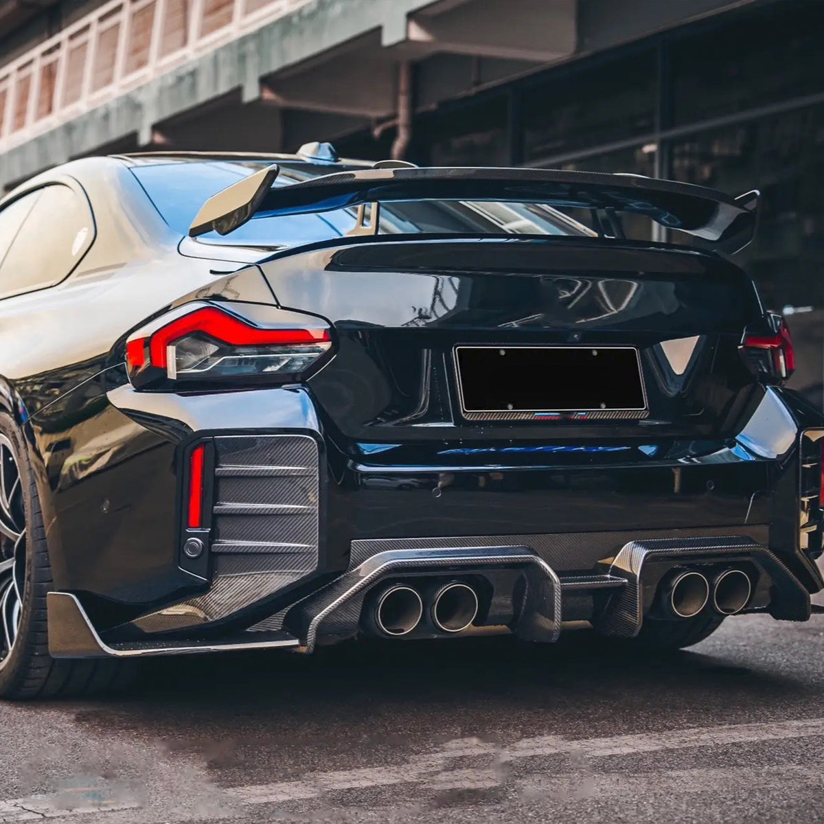 Dark BMW G87 M2 with carbon fiber rear diffuser and wing (AD Style)