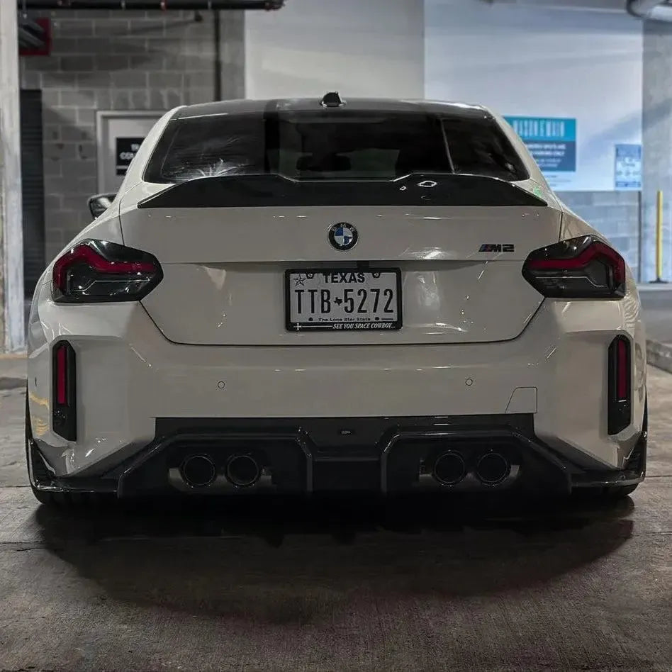 Rear of a white BMW G87 M2 with carbon fiber rear diffuser (AD V1 Style)