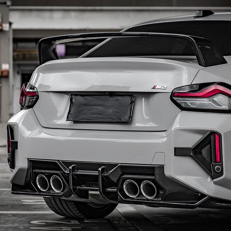 Rear of a white BMW G87 M2 with carbon fiber rear diffuser (PM V2 Style)