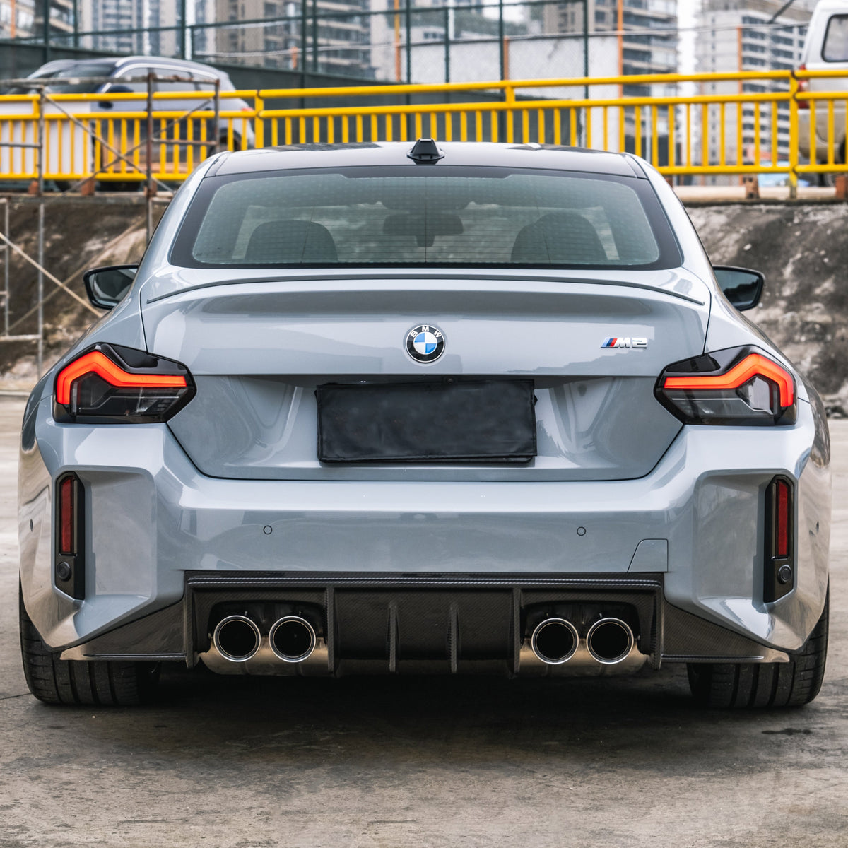 Rear of a gray BMW G87 M2 with carbon fiber rear diffuser (PM V3 Style)