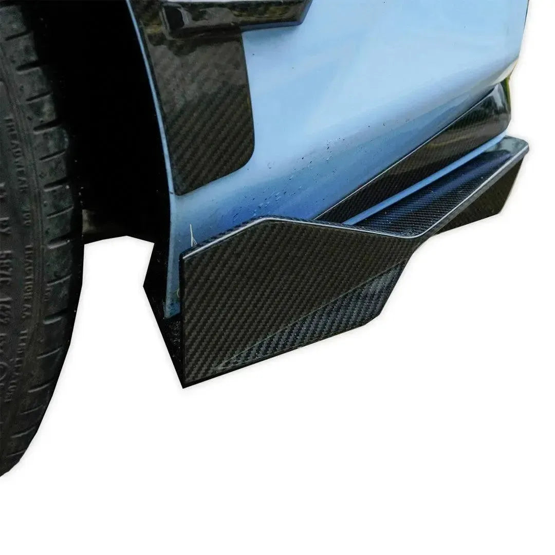 Close-up of carbon fiber rear diffuser edge on a light blue BMW G87 M2 (V Style)