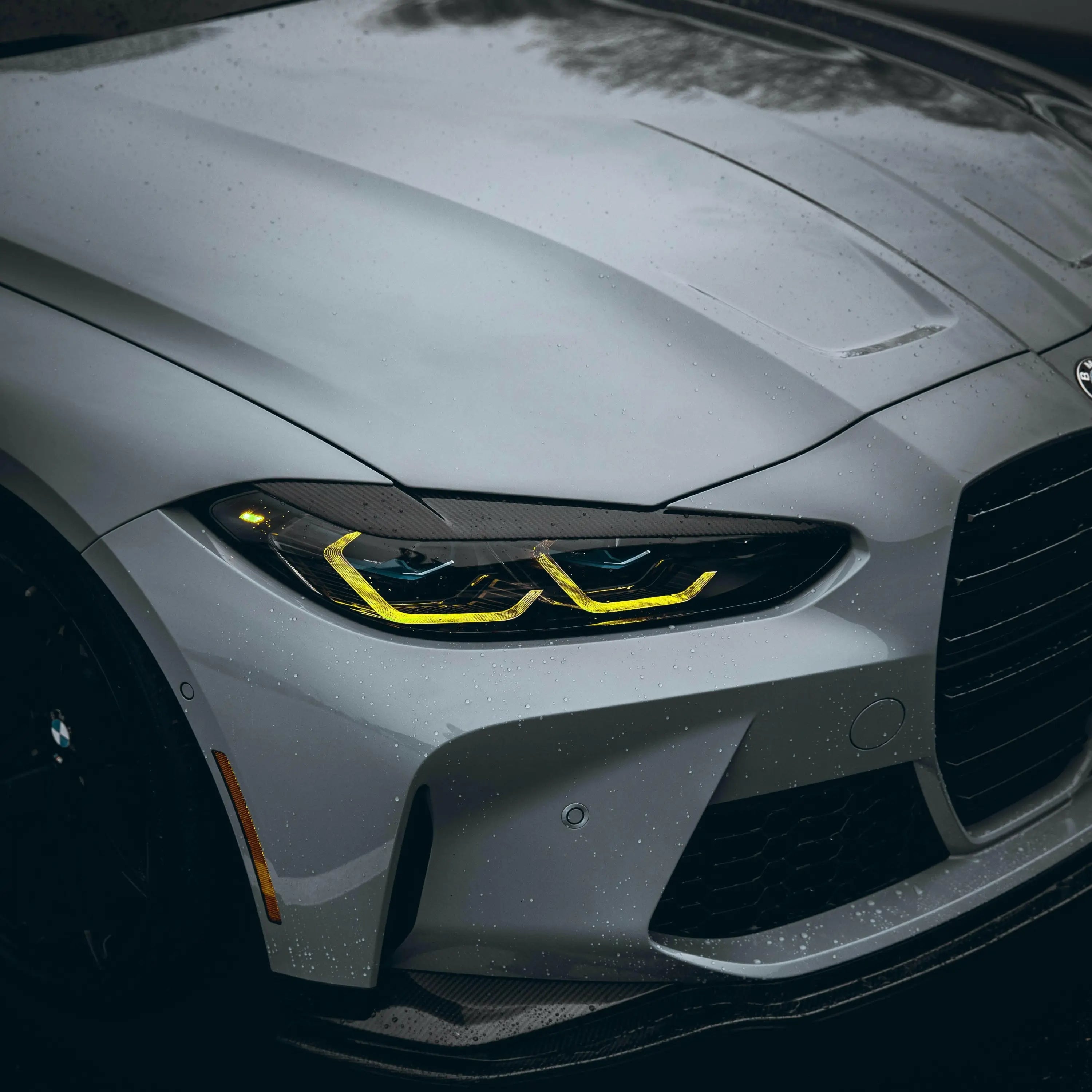 A karbon szálas első fényszóró pár bmw g80 m3 és g82 m4 kipufogó rendszerhez sárga led díszítéssel