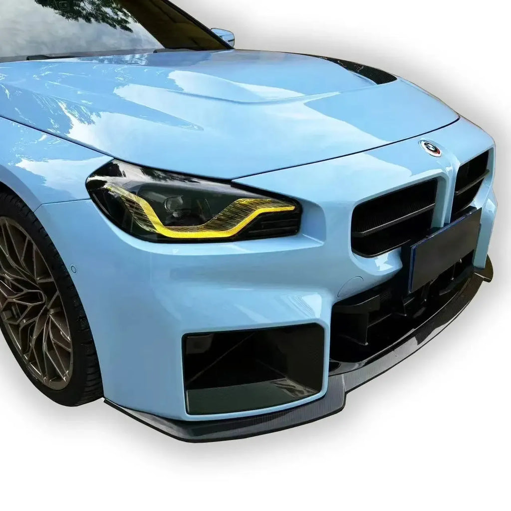 Close-up of a light blue BMW G87 M2 front with carbon fiber front lip (AN GT Style)