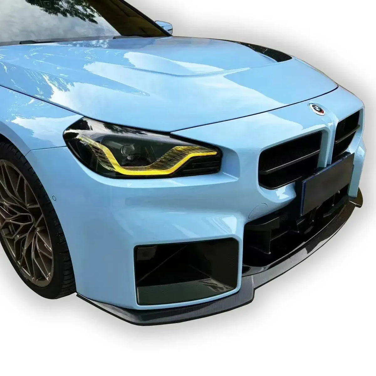 Close-up of a light blue BMW G87 M2 front with carbon fiber front lip (AN GT Style)