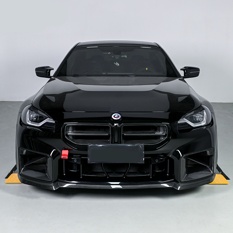 Front of a black BMW G87 M2 with carbon fiber front lip (CS Style)