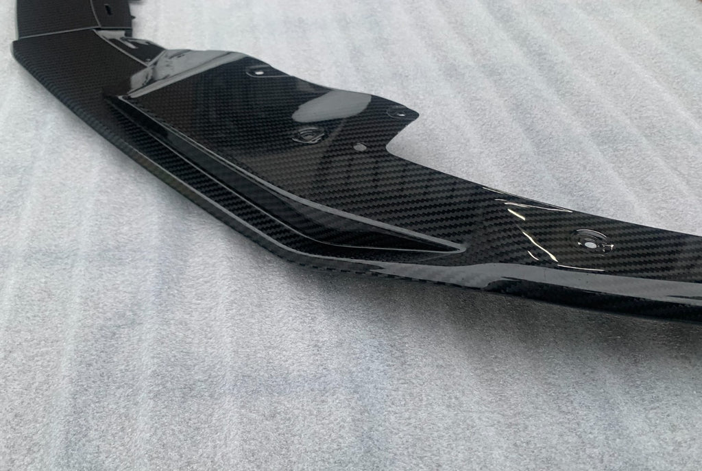 Close-up of the carbon front splitter side piece, on a fabric background (OEM Style) – Audi R8 4S Facelift