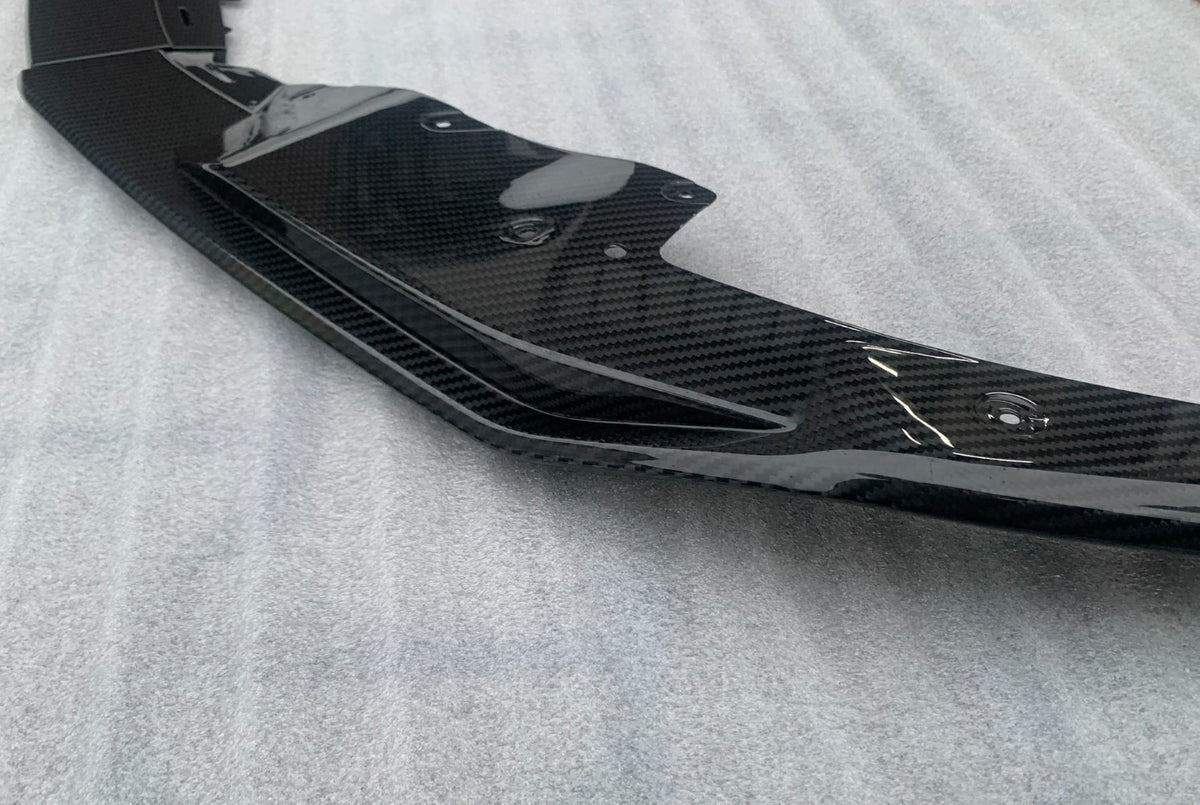Close-up of the carbon front splitter side piece, on a fabric background (OEM Style) – Audi R8 4S Facelift