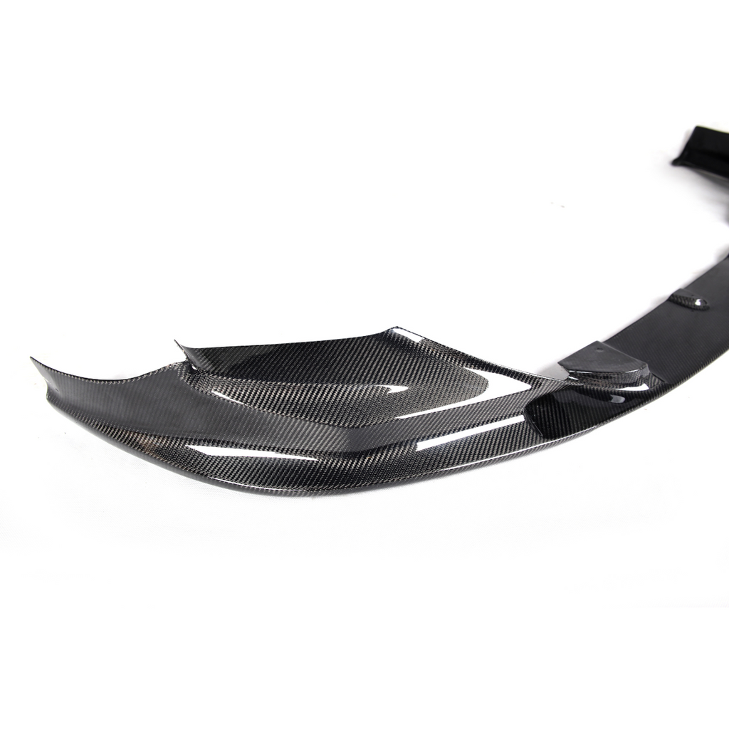 Close-up of the carbon front lip winglet corner piece, on a white background (3D Style) – BMW F90 M5