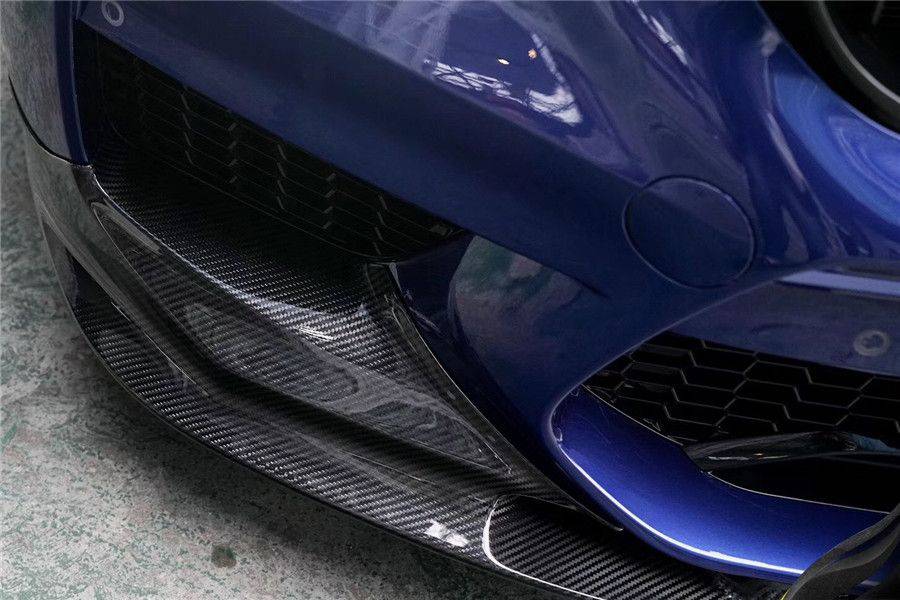 Close-up of the carbon front lip corner and weave pattern on a blue BMW F90 M5 bumper (D3 Style)