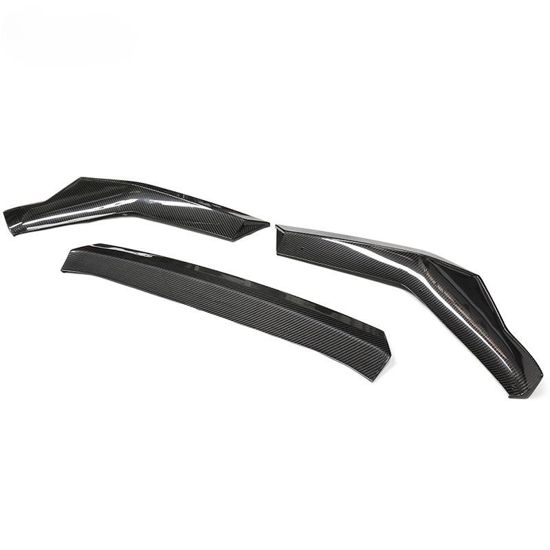 Three pieces of the carbon front lip from another angled view, on a white background (PM Style) – BMW F90 M5