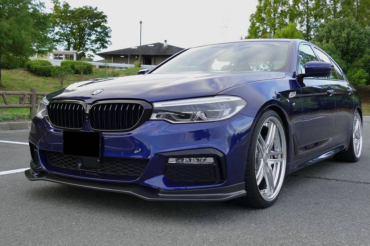 Dark blue pre-LCI BMW G30 M Sport front three-quarter view, with fitted carbon front lip (ECC Style)