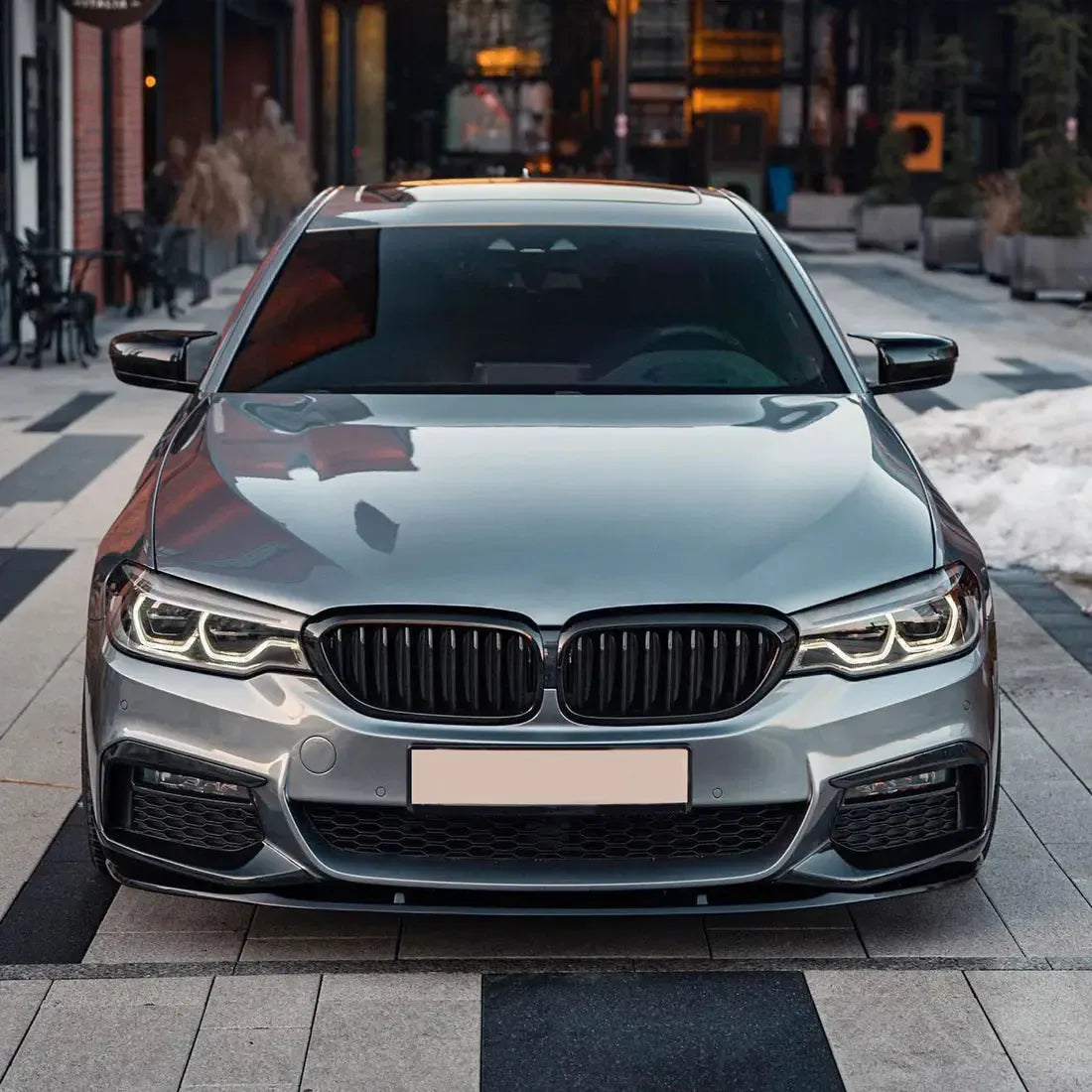 Silver pre-LCI BMW G30 M Sport head-on, with fitted carbon front lip (MP Style)