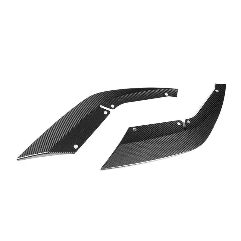 Two carbon front lip corner pieces, angled view, on a white background (Signature Style) – BMW F90 M5