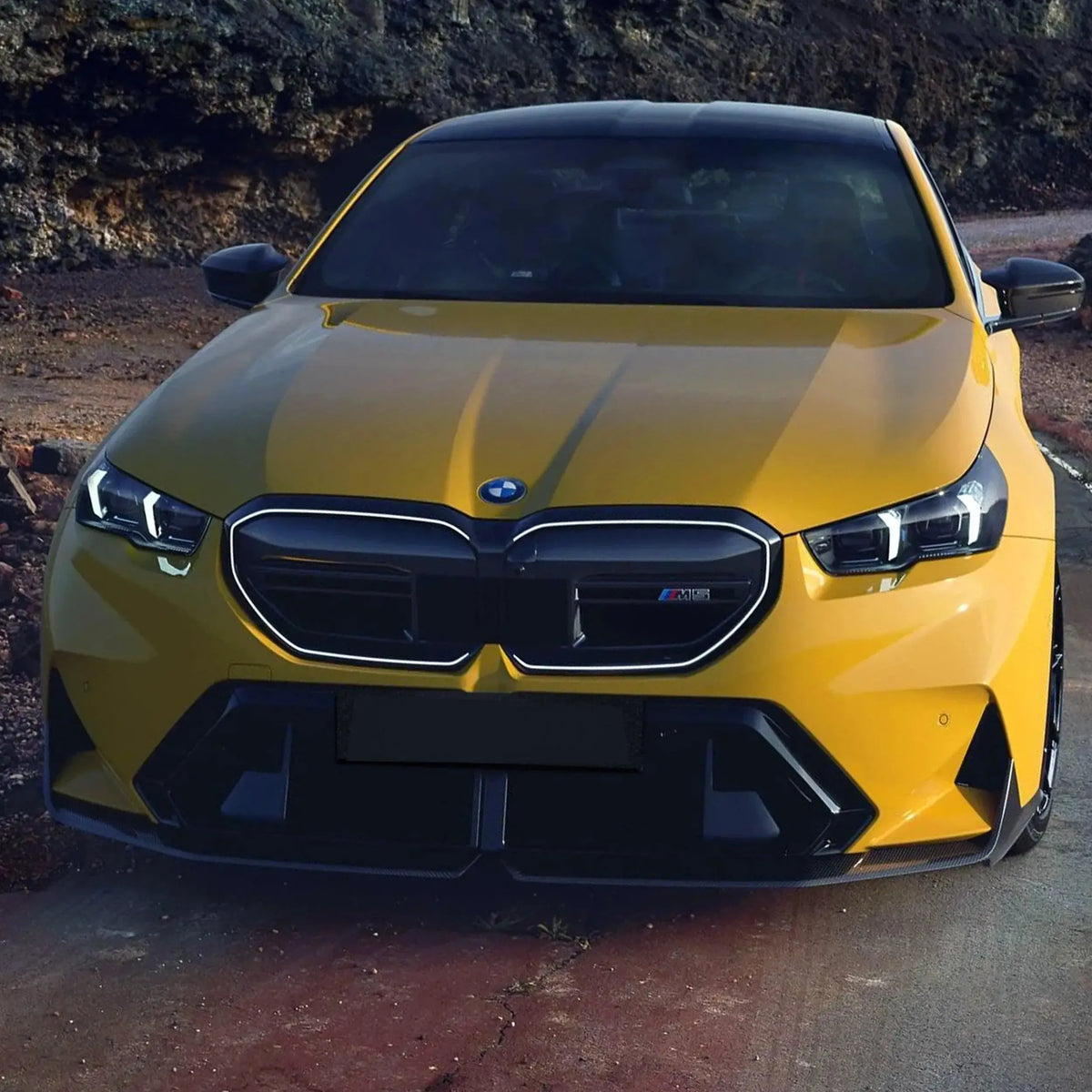 Yellow BMW G90 M5 head-on, with fitted carbon fiber front lip (MP Style)
