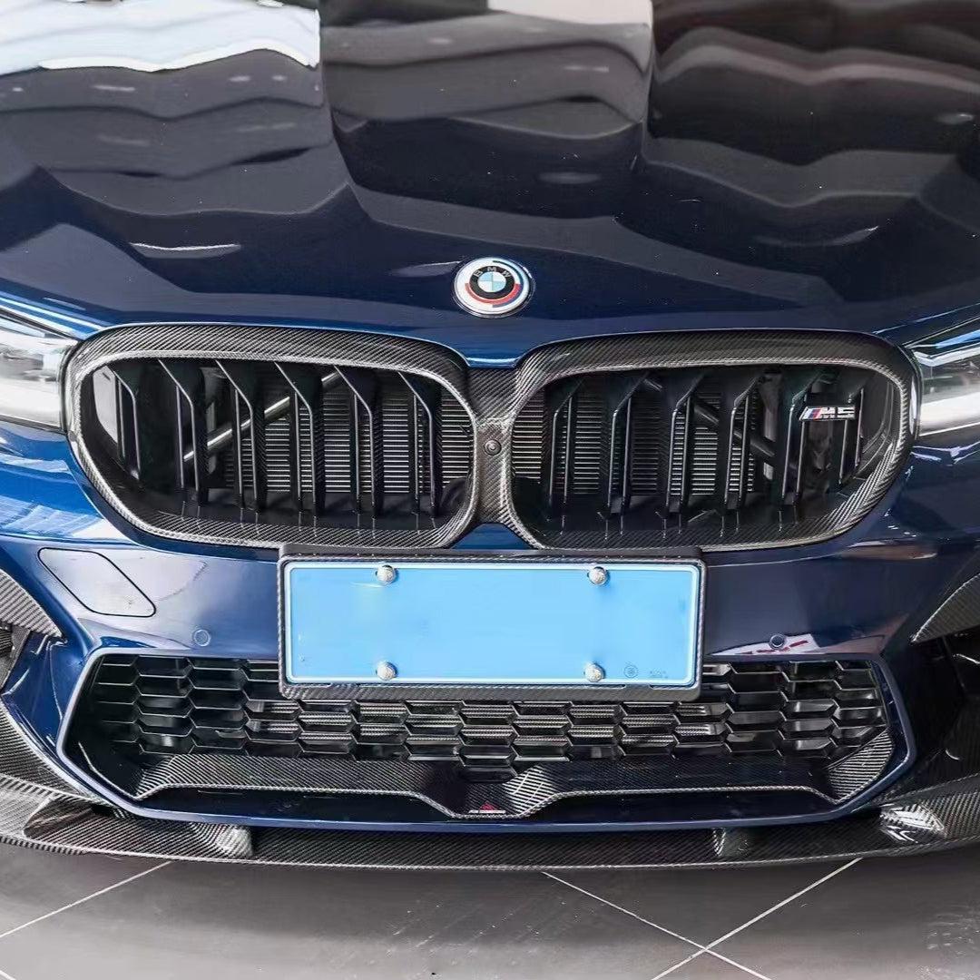 Close-up of a blue LCI BMW F90 M5 nose, with fitted double-slat carbon kidney grille