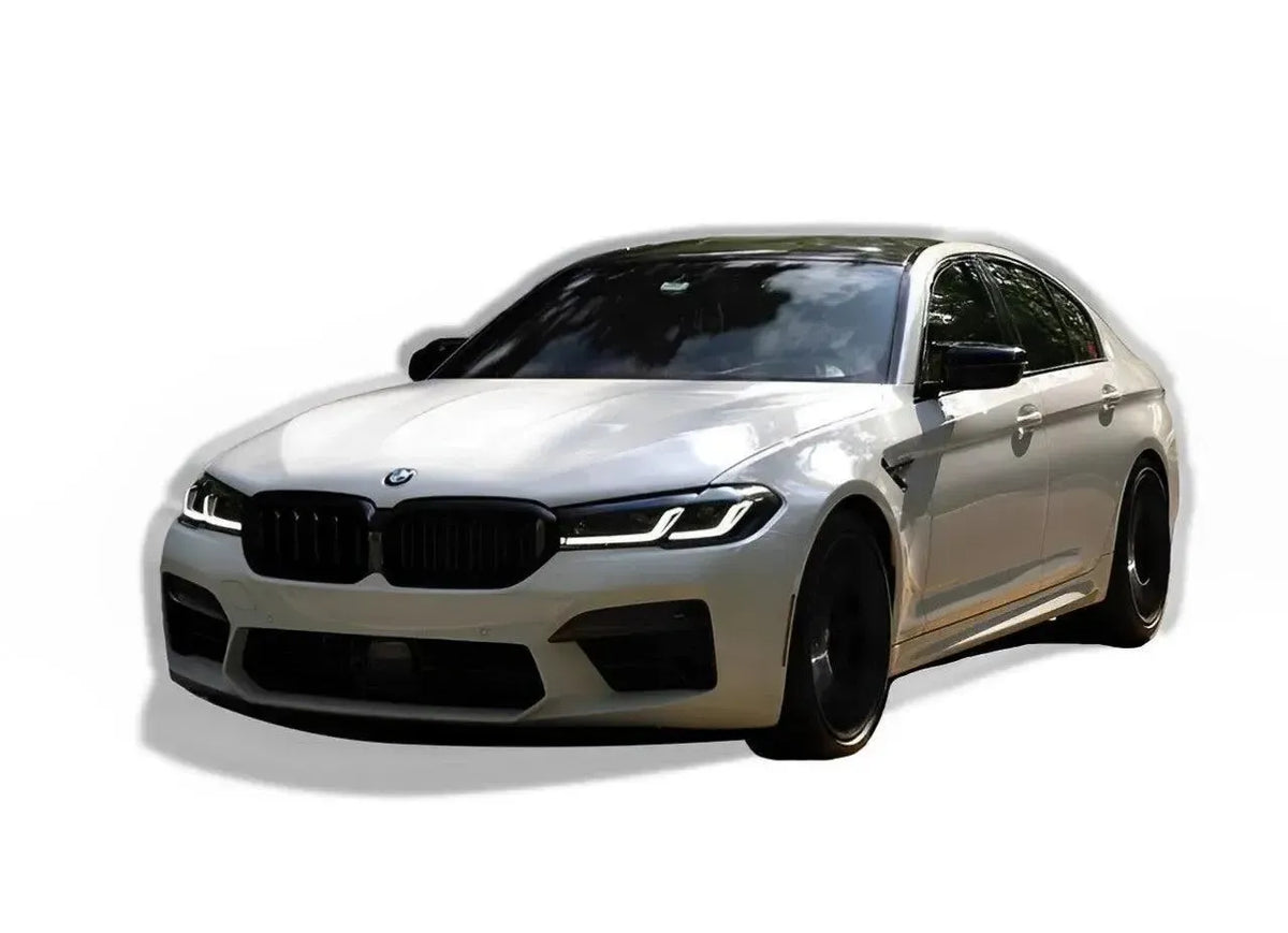 White LCI BMW F90 M5 in front three-quarter view, with gloss black double-slat kidney grille