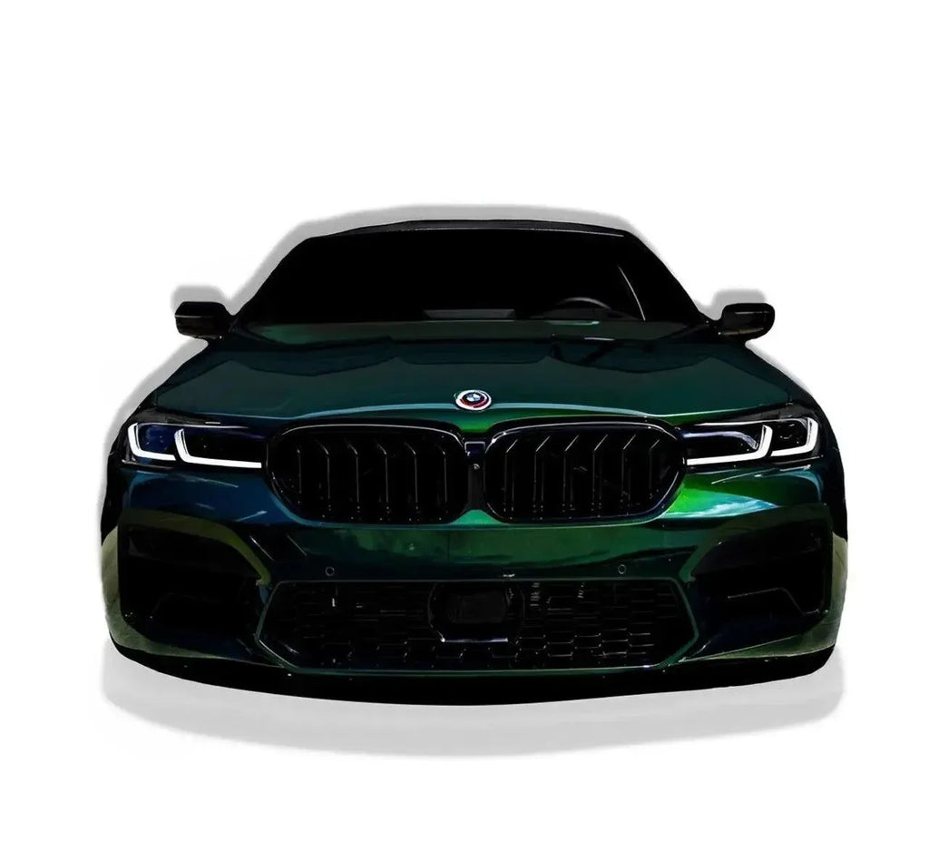 Sötétzöld LCI BMW F90 M5 elölnézetből, fényes fekete dupla rácsos vesével