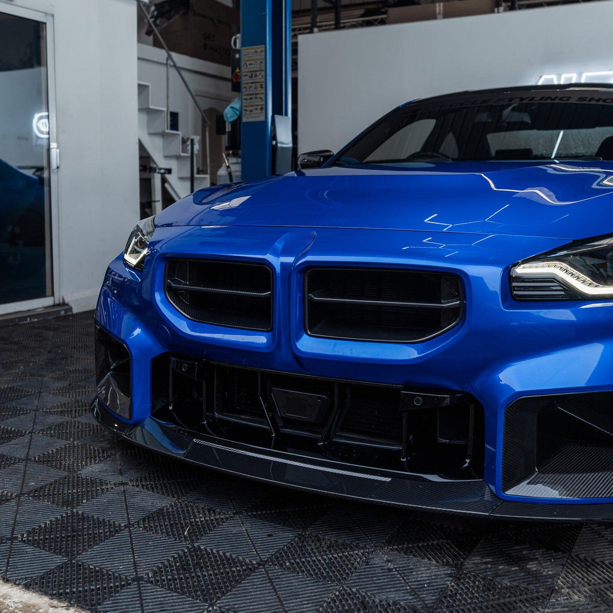 Blue BMW G87 M2 with carbon fiber front kidney grilles (MP Style)
