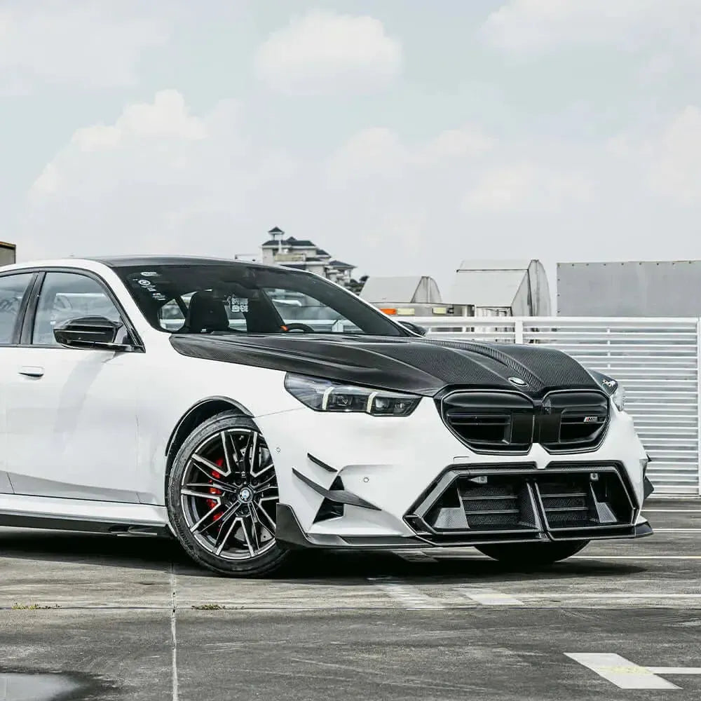 Full white BMW G90 M5 in front three-quarter view with vented carbon hood (SQ Style)