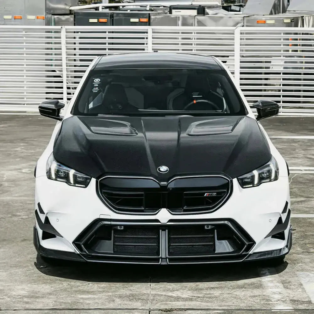 White BMW G90 M5 front view with vented carbon hood (SQ Style)