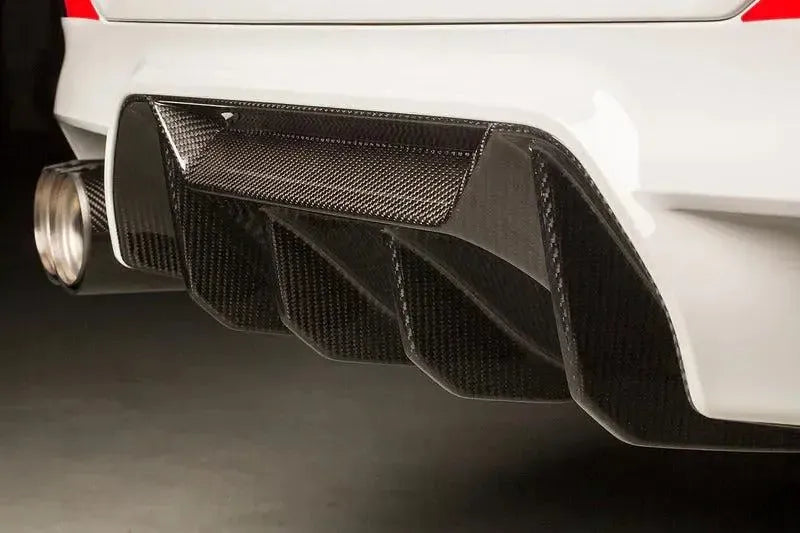 Close-up of a white BMW F90 M5 rear, with fitted gloss carbon rear diffuser (MP Style)