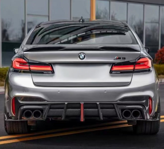 Silver BMW F90 M5 LCI from the rear, with finned carbon diffuser and red LED brake light (Track Style)