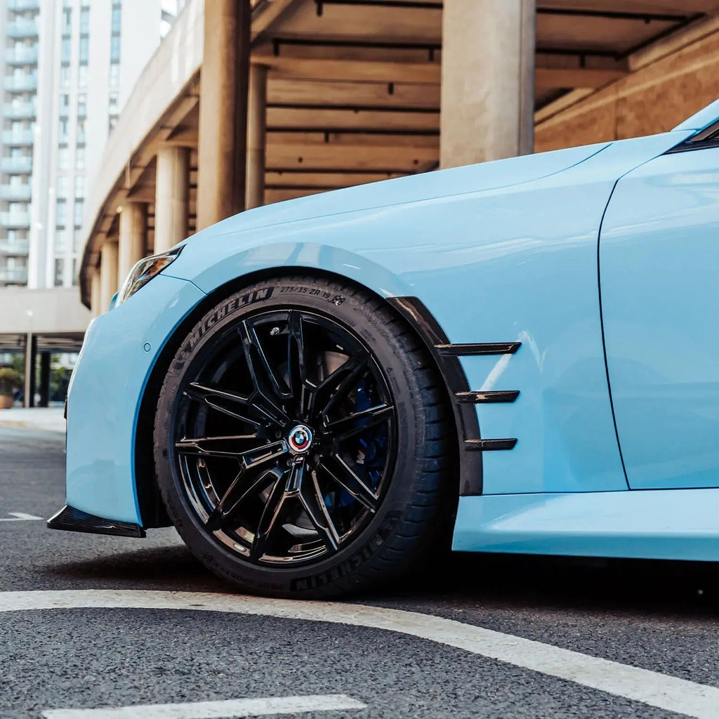 Light blue bmw sports car with carbon fiber kerékív sárvédő betét and michelin tires for bmw m3 kipufogó rendszer