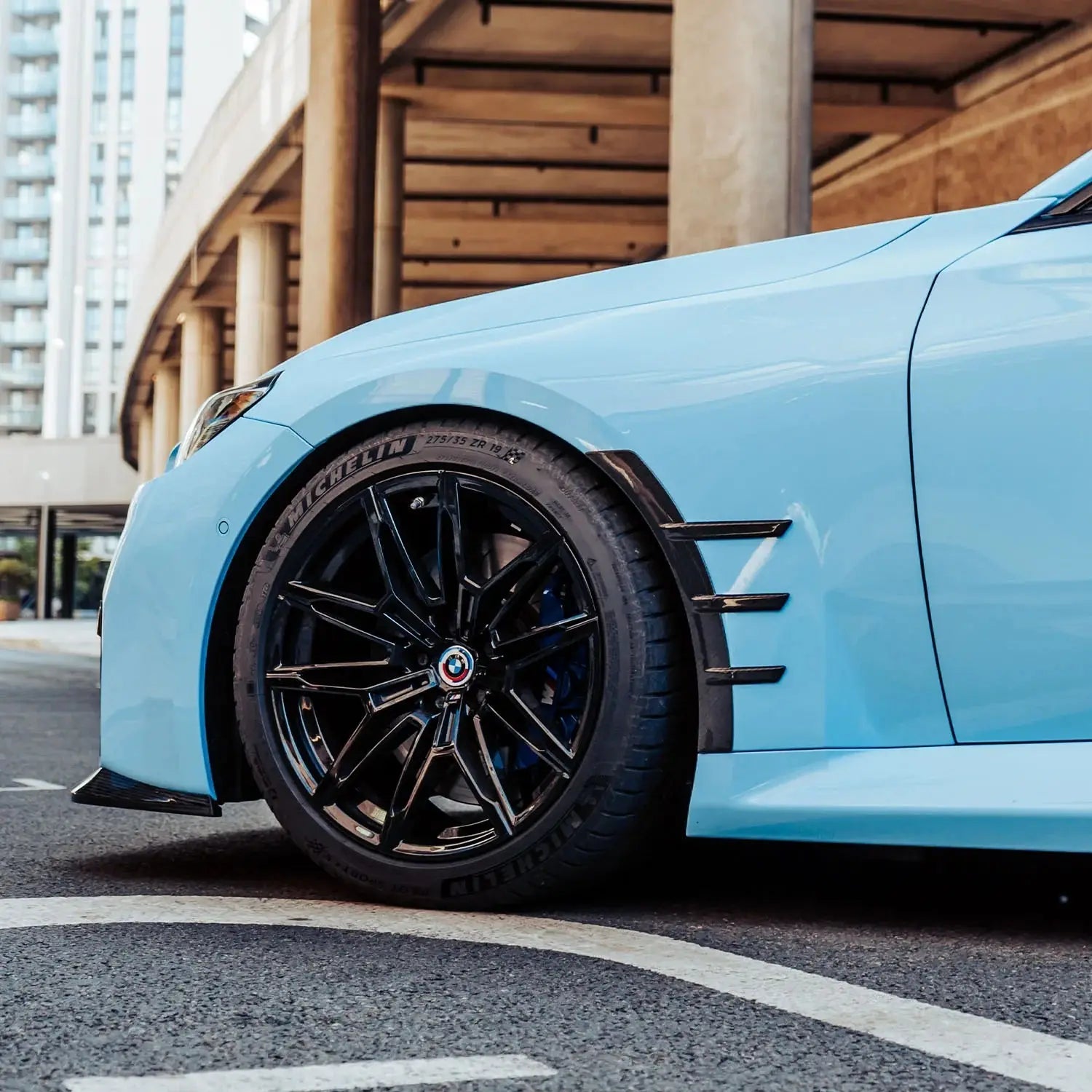 Light blue bmw sports car with carbon fiber kerékív sárvédő betét and michelin tires for bmw m3 kipufogó rendszer
