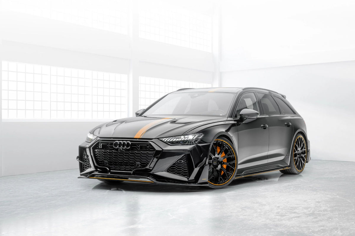 Black Audi RS6 Avant C8 in a studio, front three-quarter view, with carbon lower skirt plate (MSY Style)