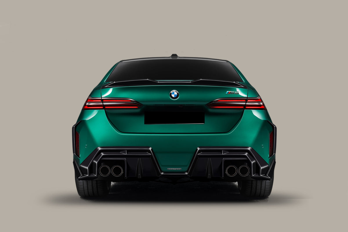 Rear view render of a green BMW G90 M5 with carbon trunk spoiler (AD Style)